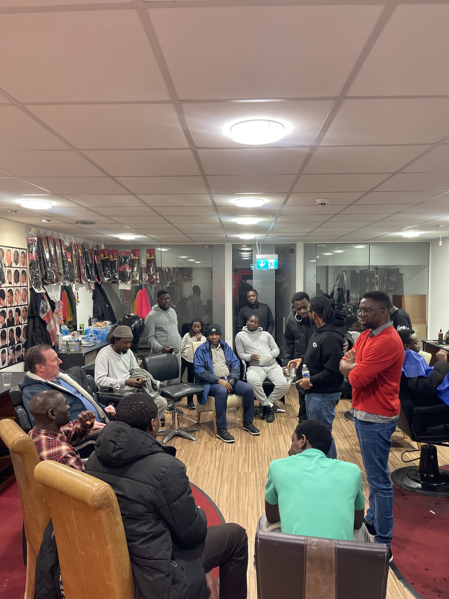 Men in honest conversation at a Fade Therapy session in a Derby barbershop.