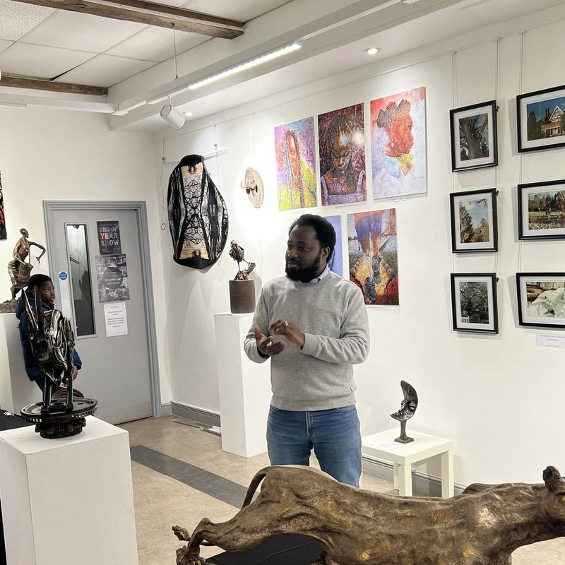 Artist speaking at the Light in the Shadows exhibition