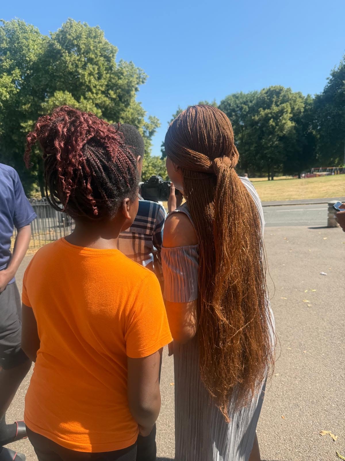 Two students taking in the park between shots