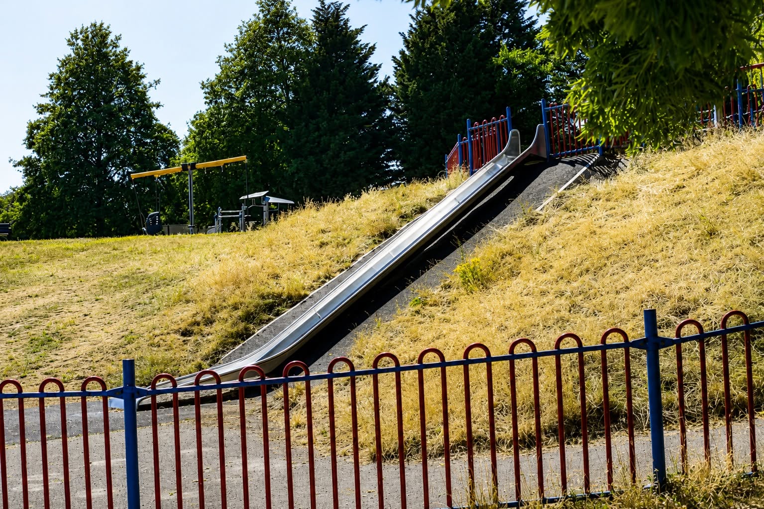 Playground slide on the grassy hill — a photograph taken by one of the workshop students